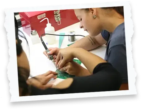 Student using a soldering iron