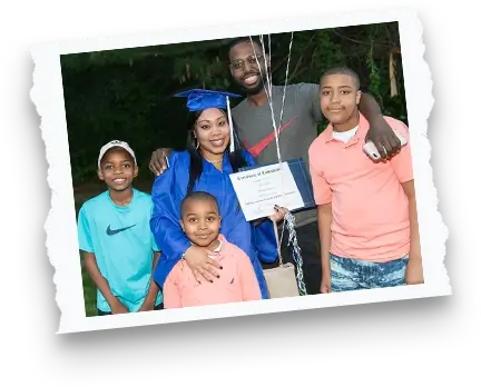 female adult graduate wearing a blue cap and gown smiling with her family